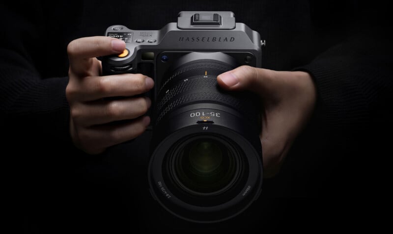 Hasselblad X2D II 100C camera held in hands, showcasing its sleek design and advanced features.